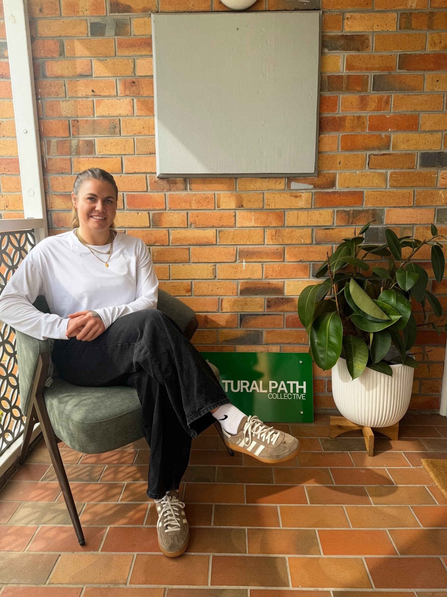 The clinic's front door, framed by greenery on a quiet Hamlyn Heights street.