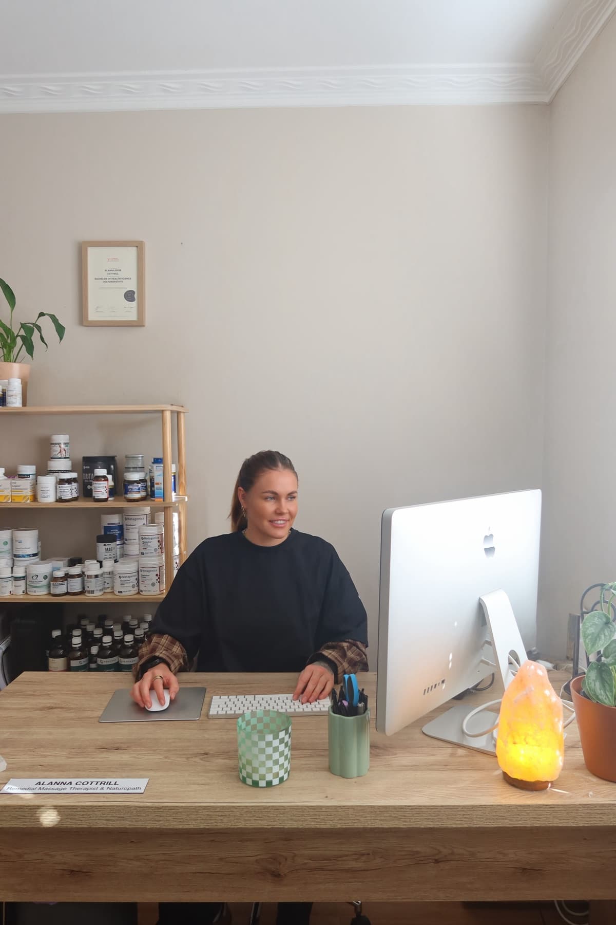 Alanna Cottrill seated at the entrance to The Natural Path Collective in Hamlyn Heights