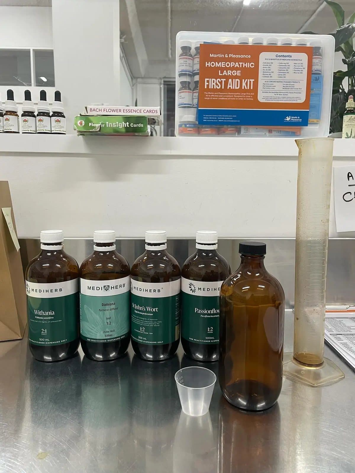 Amber glass tincture bottles lined up on the dispensary bench.